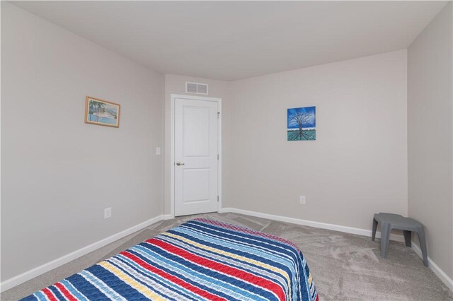 unfurnished bedroom with carpet, visible vents, and baseboards