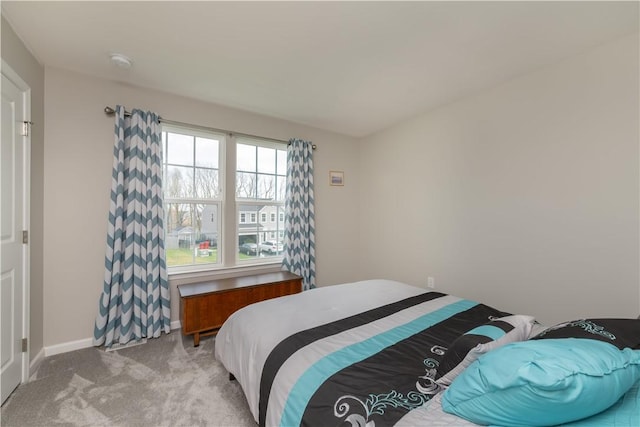 bedroom featuring baseboards and carpet