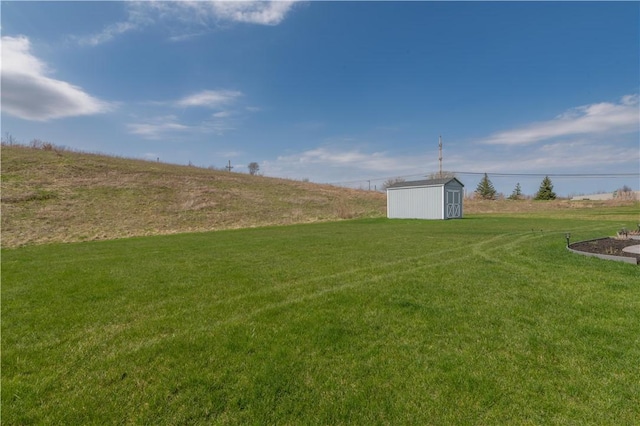 view of yard featuring an outbuilding and a storage shed