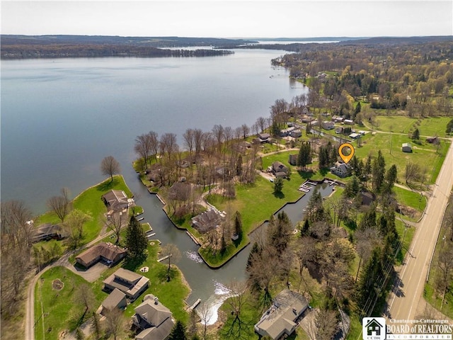 drone / aerial view featuring a residential view and a water view