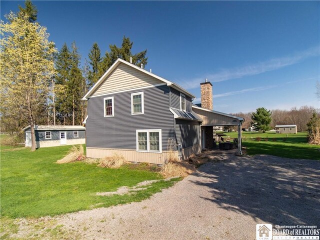 view of property exterior with a lawn and a chimney