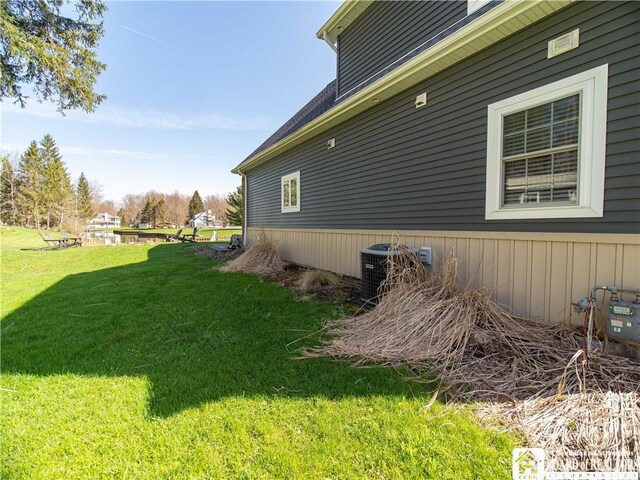 view of home's exterior featuring a yard and central air condition unit