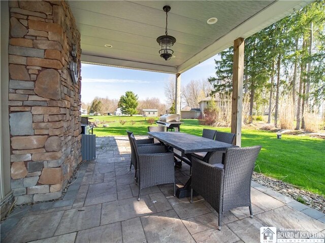 view of patio / terrace featuring outdoor dining area and a grill