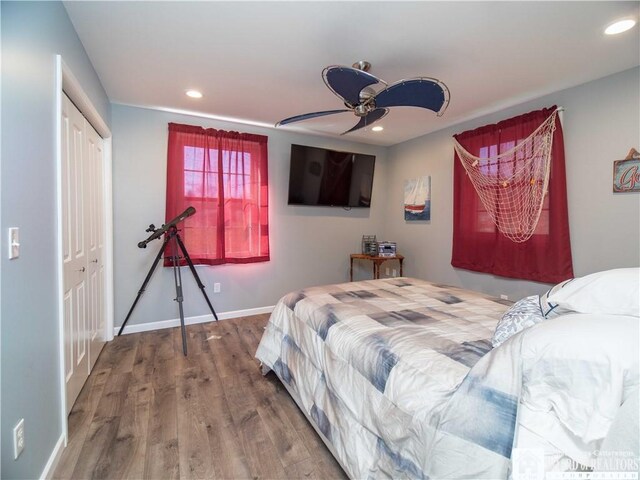 bedroom with a closet, wood finished floors, and recessed lighting