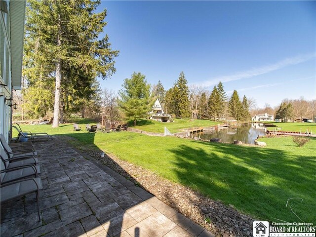 view of yard with a patio and a water view