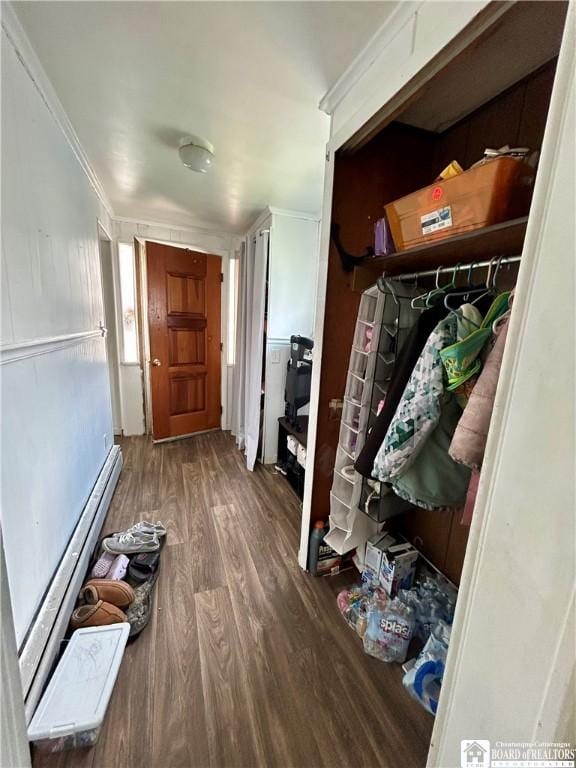 mudroom with ornamental molding, wood finished floors, and a baseboard radiator