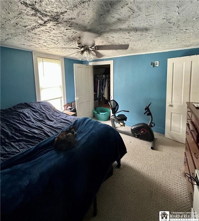 bedroom with a ceiling fan and a closet