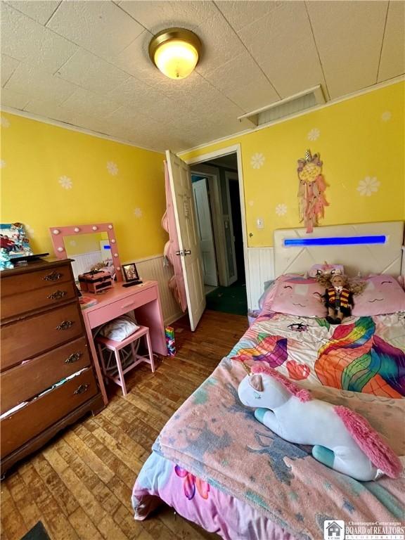 bedroom featuring wainscoting