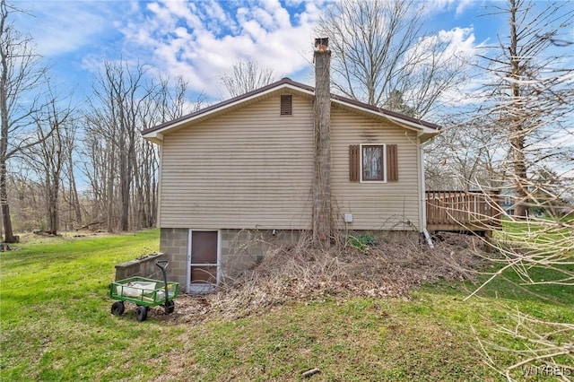 view of home's exterior featuring a yard and a chimney