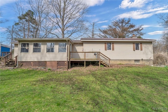 rear view of house with stairway, a wooden deck, and a lawn