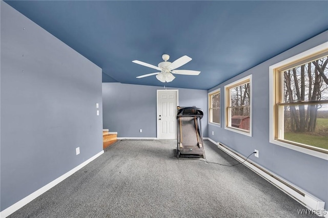 workout area with a baseboard radiator, baseboards, ceiling fan, and plenty of natural light