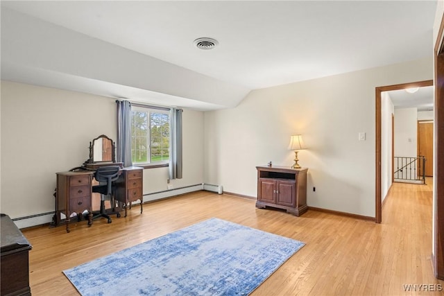 office area featuring a baseboard heating unit, light wood-style floors, visible vents, and baseboards