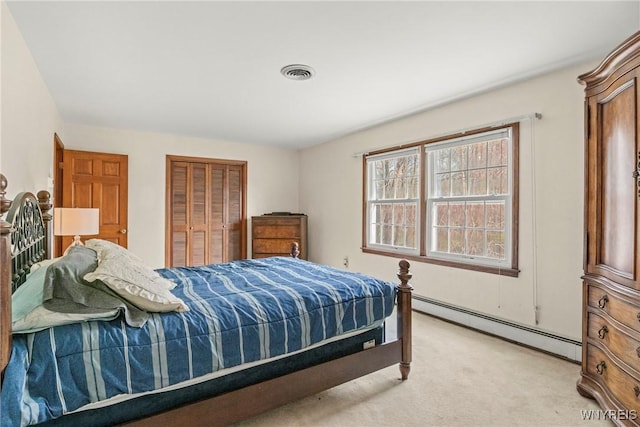 bedroom with a closet, visible vents, baseboard heating, and light colored carpet