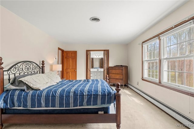 bedroom with ensuite bath, a baseboard radiator, carpet floors, and visible vents