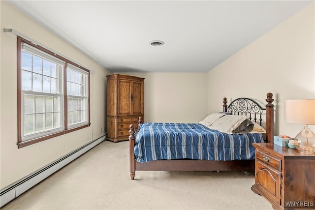 bedroom with light colored carpet, a baseboard radiator, and visible vents