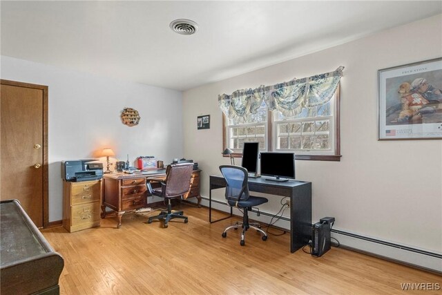 office space featuring baseboard heating, visible vents, and light wood-style floors