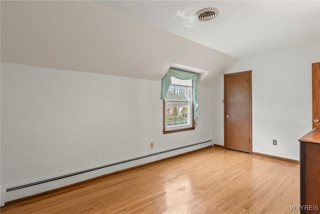 bonus room featuring baseboard heating, baseboards, visible vents, and light wood-type flooring