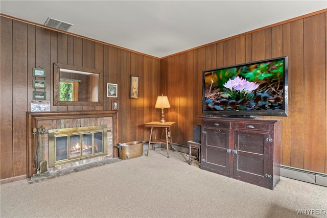 living area with a glass covered fireplace, wooden walls, visible vents, and carpet flooring