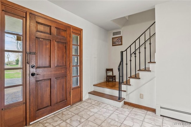 entrance foyer with marble finish floor, visible vents, a baseboard heating unit, baseboards, and stairs