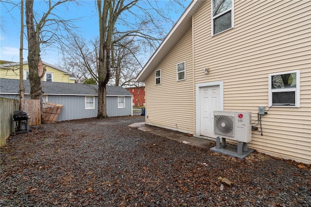 back of property featuring fence and ac unit