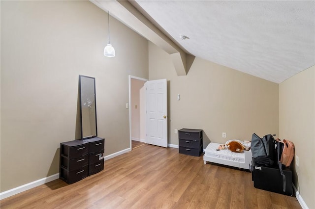 bonus room with high vaulted ceiling, light wood finished floors, and baseboards