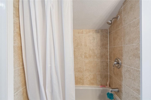 full bath featuring shower / bath combination with curtain and a textured ceiling