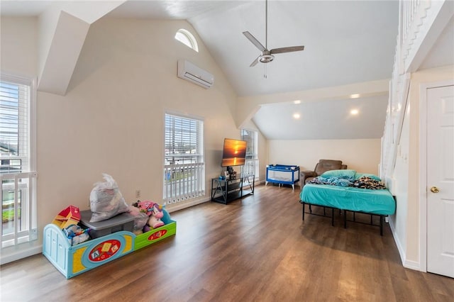 bedroom featuring wood finished floors, an AC wall unit, and multiple windows