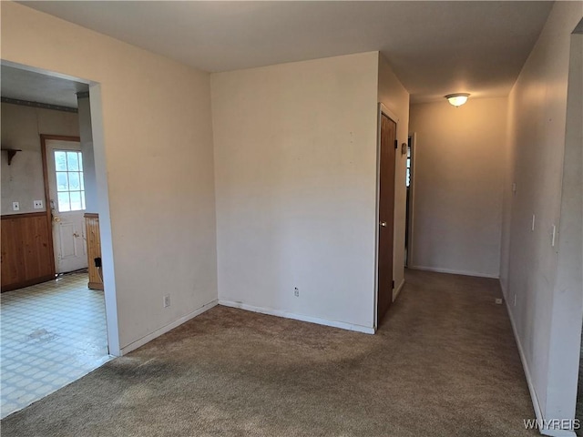 carpeted spare room with baseboards