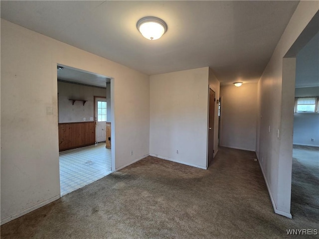 empty room featuring baseboards and carpet