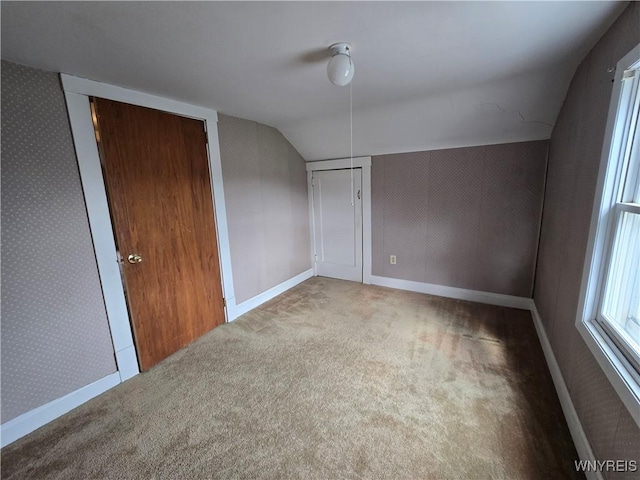 bonus room with vaulted ceiling, baseboards, and carpet