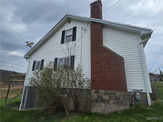 view of property exterior with a chimney