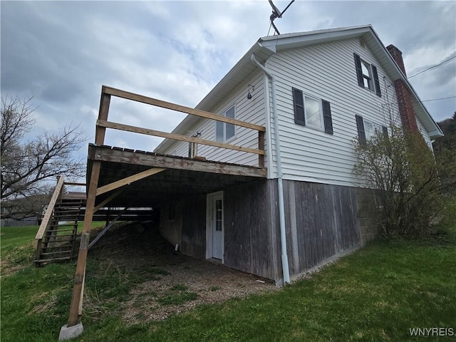 rear view of property with stairway, a chimney, and a deck