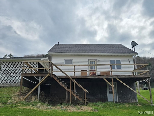 rear view of house featuring stairway and a deck