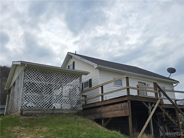 back of house featuring a wooden deck and stairway