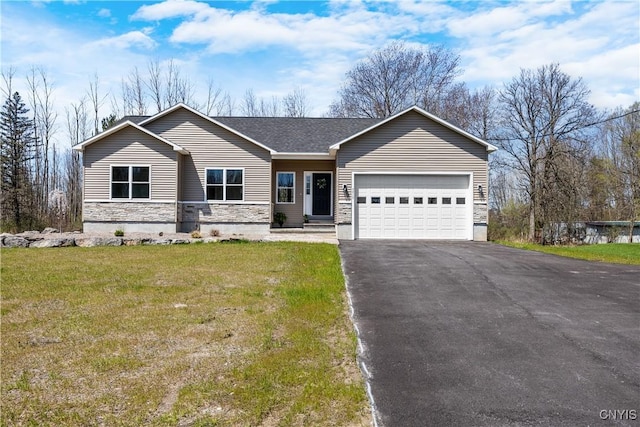 7717 Roberts St, Lenox, NY 13032 - view of front of home featuring an attached garage, stone siding, a front lawn, and aphalt driveway