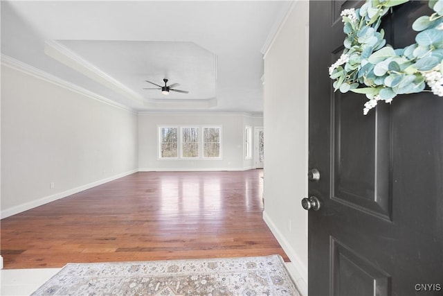 7717 Roberts St, Lenox, NY 13032 - entrance foyer with a raised ceiling, wood finished floors, ornamental molding, baseboards, and ceiling fan