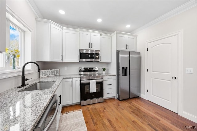 7717 Roberts St, Lenox, NY 13032 - kitchen featuring ornamental molding, a sink, white cabinetry, and appliances with stainless steel finishes