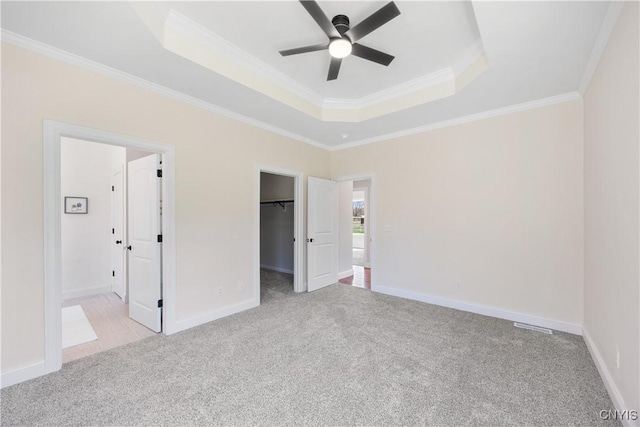 7717 Roberts St, Lenox, NY 13032 - unfurnished bedroom with a spacious closet, a raised ceiling, ornamental molding, baseboards, and carpet flooring