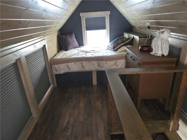 bedroom with vaulted ceiling and wood finished floors
