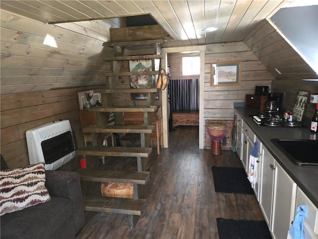 kitchen with wood ceiling, heating unit, wooden walls, and black cooktop