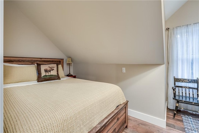 5410 N Shore Rd, Greig, NY 13312 - bedroom with baseboards, vaulted ceiling, and light wood-style flooring