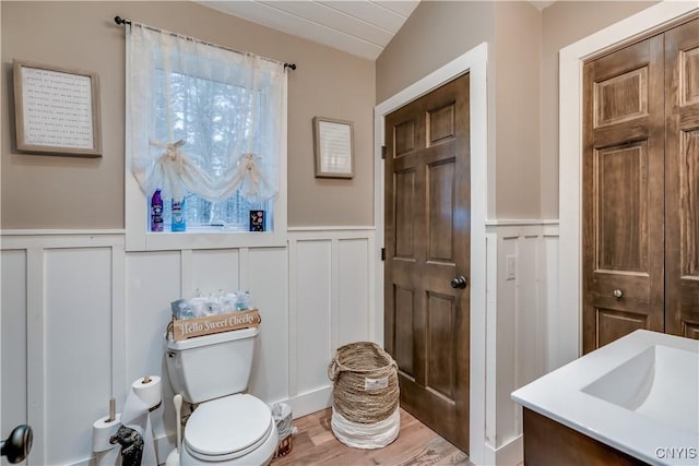 5410 N Shore Rd, Greig, NY 13312 - bathroom featuring wainscoting, a decorative wall, and plenty of natural light