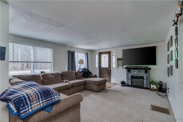 5410 N Shore Rd, Greig, NY 13312 - living area featuring baseboards, a stone fireplace, visible vents, and carpet floors
