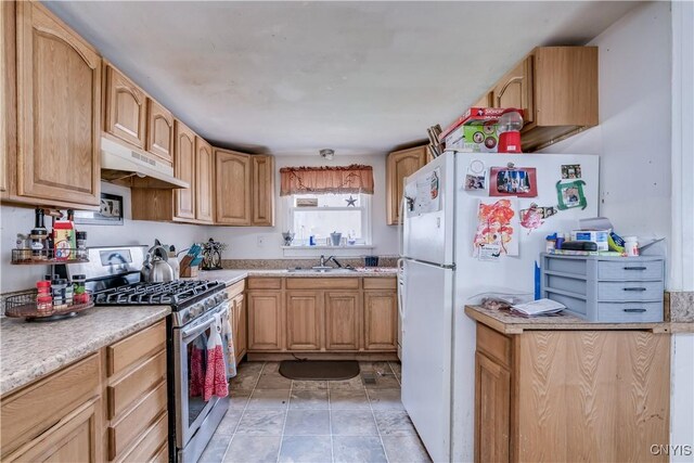 5410 N Shore Rd, Greig, NY 13312 - kitchen featuring a sink, freestanding refrigerator, light countertops, under cabinet range hood, and stainless steel gas range oven
