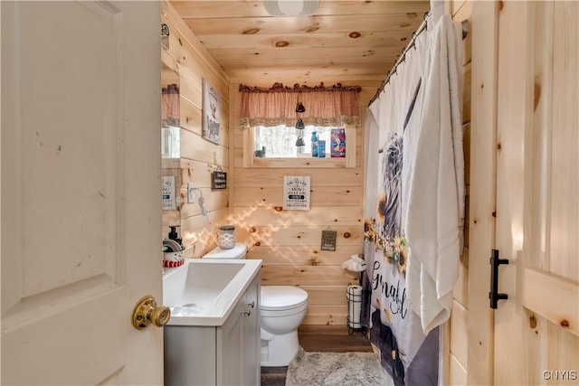 5410 N Shore Rd, Greig, NY 13312 - bathroom featuring toilet, wooden walls, wood finished floors, wooden ceiling, and vanity