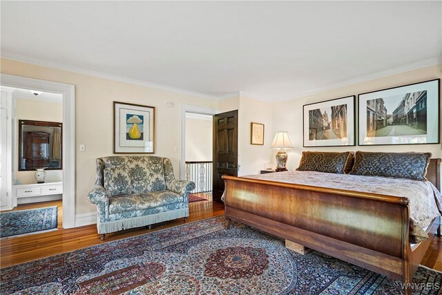 bedroom featuring crown molding and wood finished floors