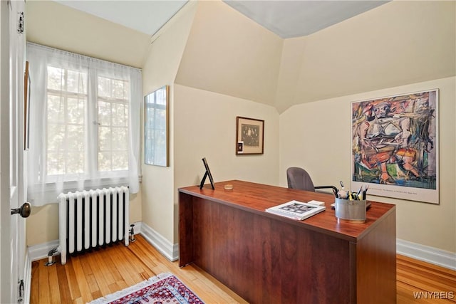 home office with radiator, light wood finished floors, and baseboards