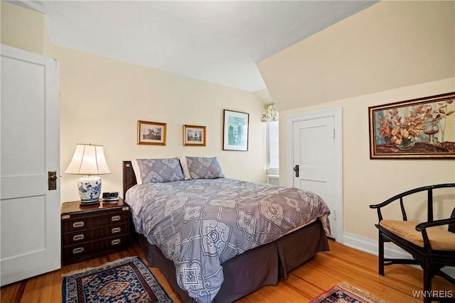 bedroom with wood finished floors and baseboards