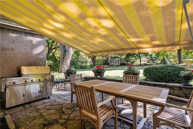 view of patio / terrace featuring an outbuilding and outdoor dining space