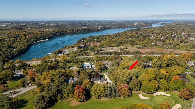 birds eye view of property with view of golf course and a water view